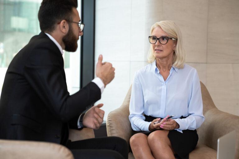 Mature businesswoman discussing project with business partner at meeting