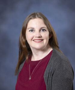 Relaxed woman smiling headshot for holistic health therapy.