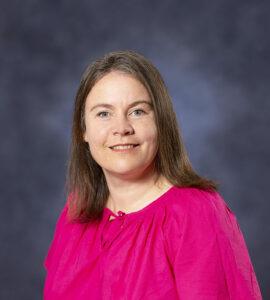 Comfortable woman smiling, promoting holistic health, wellness coaching, and therapy services at Mind & Body Works.