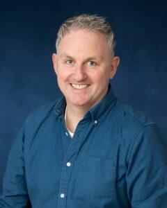 Relaxed man smiling, health and wellness professional, strategic therapy for mind and body.