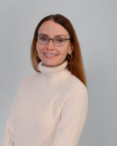 Relaxed woman with glasses and earrings representing mental wellness and holistic health.