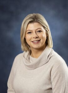 Relaxed woman smiling at the camera, wellness, therapy and mental health concept.