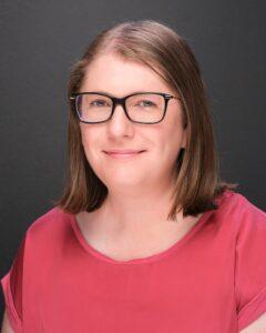 Calm woman with glasses smiling, promoting mental health and well-being at Mind & Body Works.