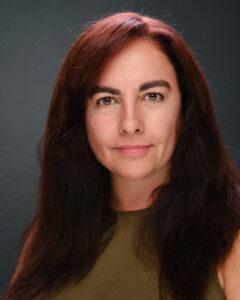 Relaxed woman with dark brown and red hair, promoting wellness and mental health.