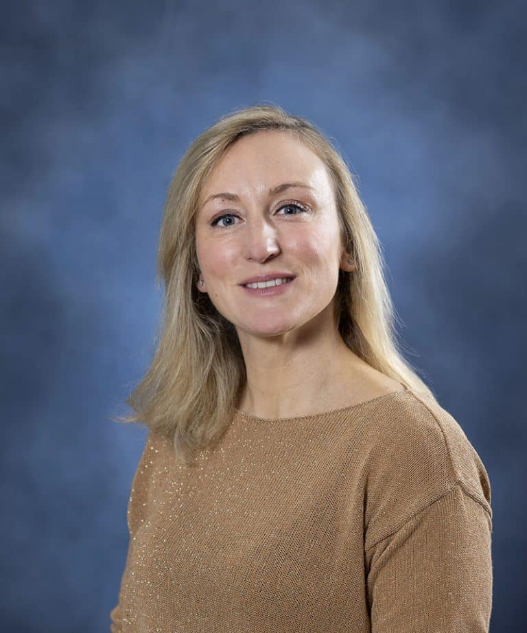 Confident woman smiling, health and wellness expert at Mind & Body Works.