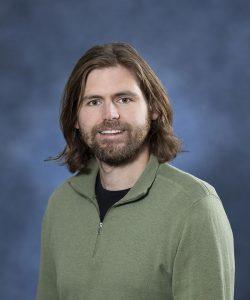 Male therapist with long brown hair and beard at Mind & Body Works.