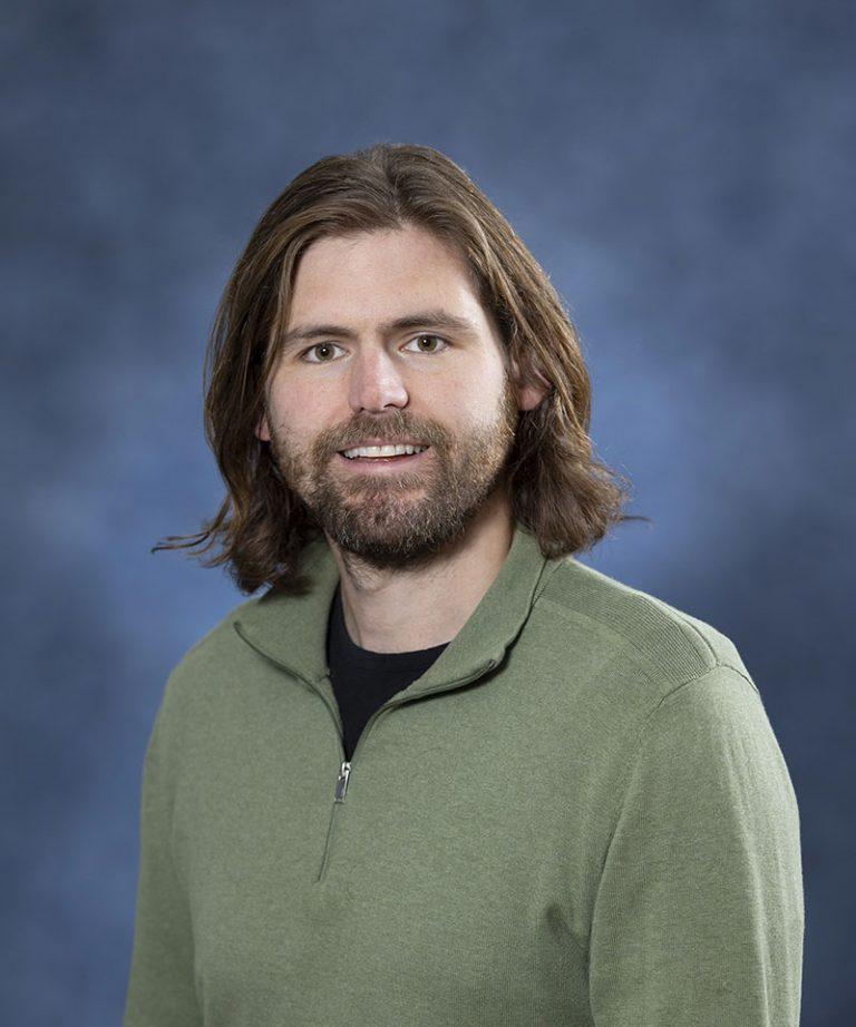 Male therapist with long brown hair and beard at Mind & Body Works.