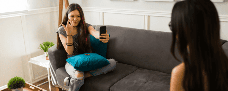 Teen girl talking to therapist during counselling session in a bright room.