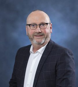Portrait of a professional man in business attire for wellness and health services.