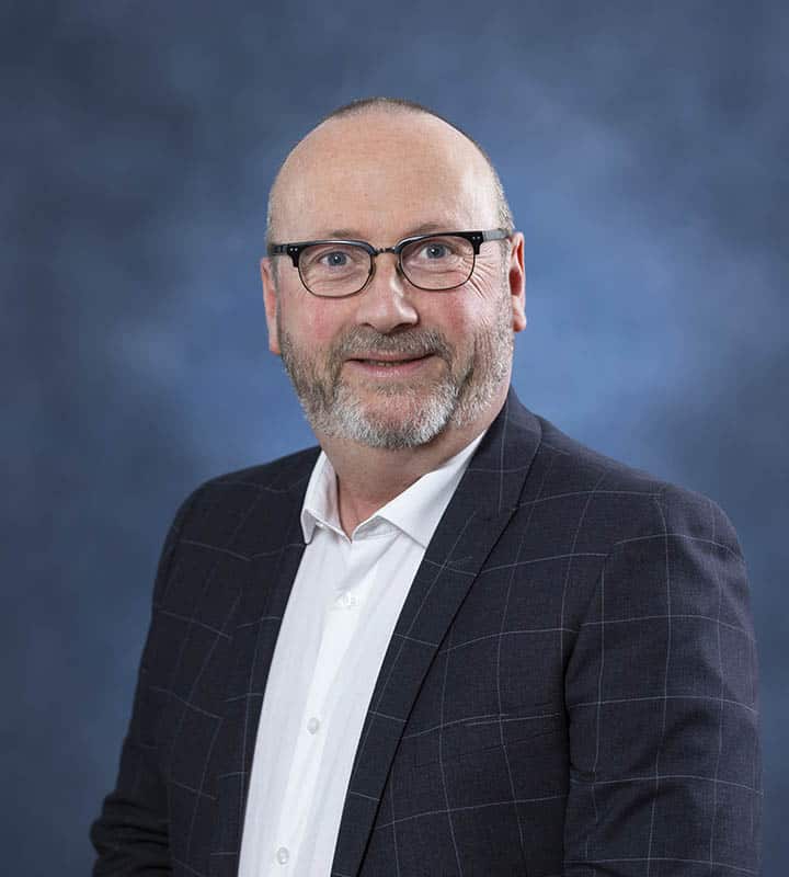 Portrait of a professional man in business attire for wellness and health services.