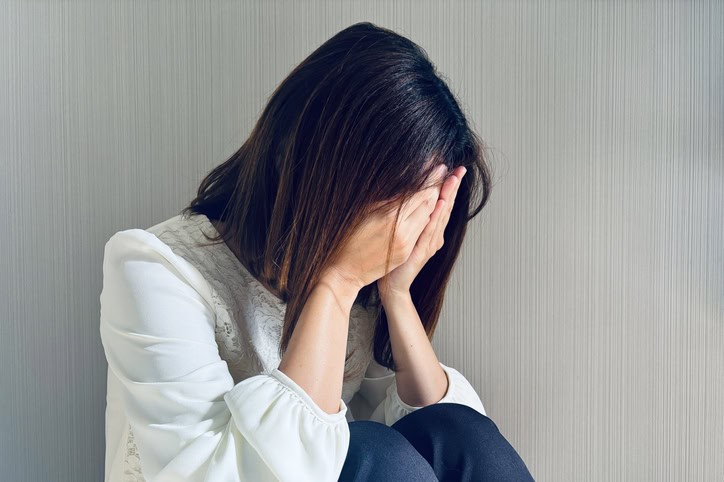 Woman experiencing stress or anxiety, seeking relaxation and mental health support.