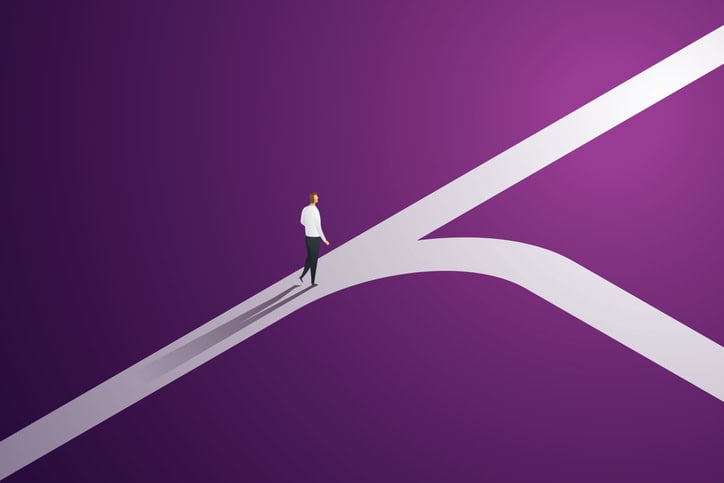 A person walking along a split path representing decision-making or life choices.