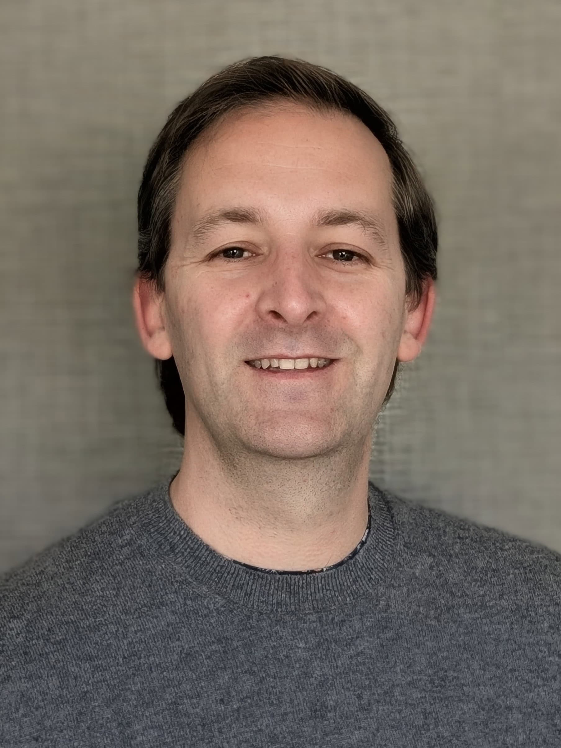 Relaxed man smiling, promoting wellness and mental health at Mind & Body Works.