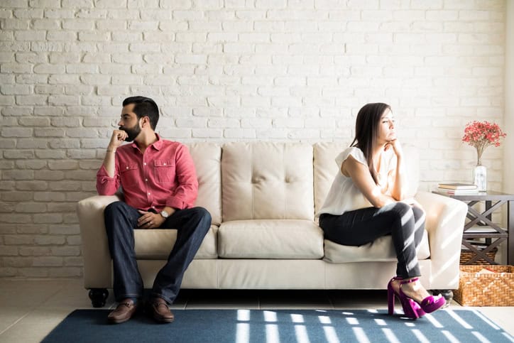 A woman and man sitting on a sofa, waiting for therapy or counselling session.